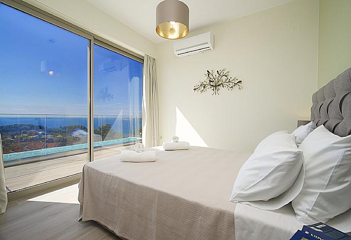 Air conditioned double bedroom with terrace access and beautiful view . - Villa Lassi Fos . (Photo Gallery) }}