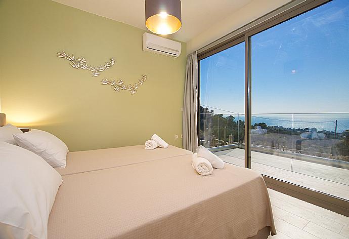 Air conditioned twin bedroom with terrace access and beautiful view  . - Villa Lassi Fos . (Photo Gallery) }}