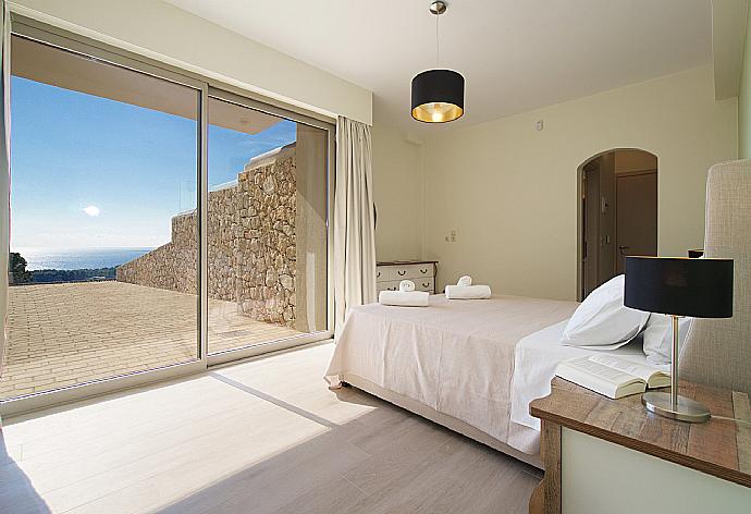 Double bedroom with  beautiful view and terrace access . - Villa Lassi Fos . (Photo Gallery) }}