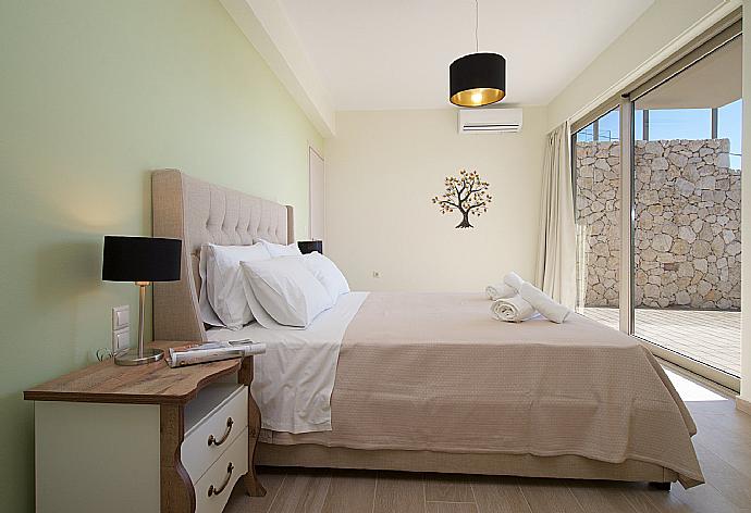 Double bedroom with  beautiful view and terrace access . - Villa Lassi Fos . (Photo Gallery) }}