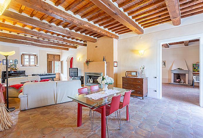 Living room with sofas, dining area, ornamental fireplace, piano, foosball table, WiFi internet, satellite TV, DVD player, and terrace access . - Villa Rossa . (Galleria fotografica) }}