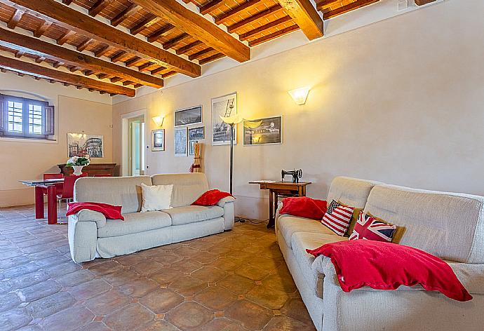 Living room with sofas, dining area, ornamental fireplace, piano, foosball table, WiFi internet, satellite TV, DVD player, and terrace access . - Villa Rossa . (Fotogalerie) }}