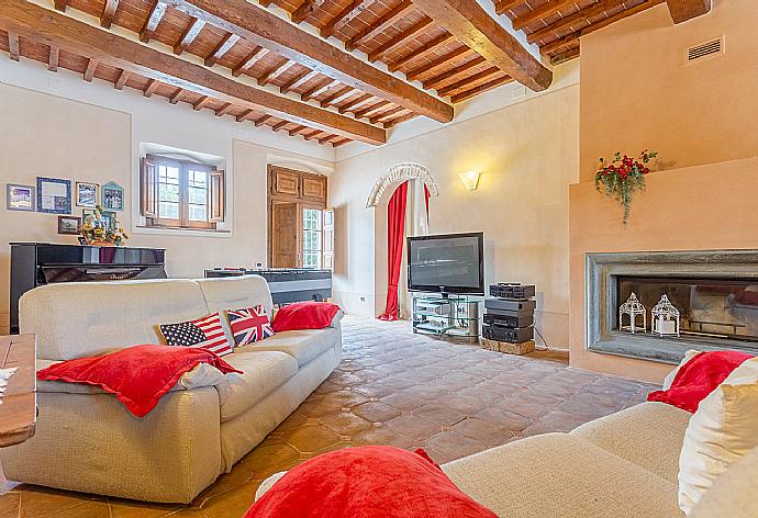 Living room with sofas, dining area, ornamental fireplace, piano, foosball table, WiFi internet, satellite TV, DVD player, and terrace access . - Villa Rossa . (Fotogalerie) }}