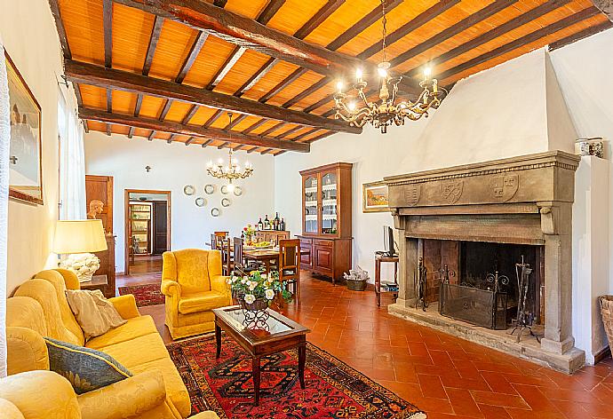 Living room with sofas, dining area, ornamental fireplace, WiFi internet, satellite TV, DVD player, and terrace access . - Villa Casa al Sole . (Photo Gallery) }}