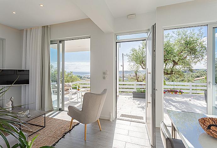 Open-plan living room with sofas, dining area, kitchen, A/C, WiFi internet, satellite TV, and terrace access with sea views . - Apartment Casalma Ena . (Galleria fotografica) }}