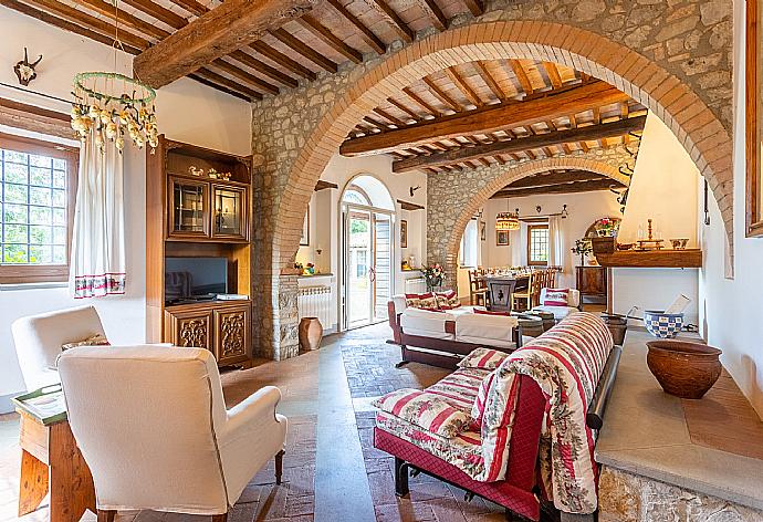 Living room on ground floor with sofas, dining area, ornamental fireplace, WiFi internet, satellite TV, and terrace access . - Villa Il Giulione . (Galleria fotografica) }}