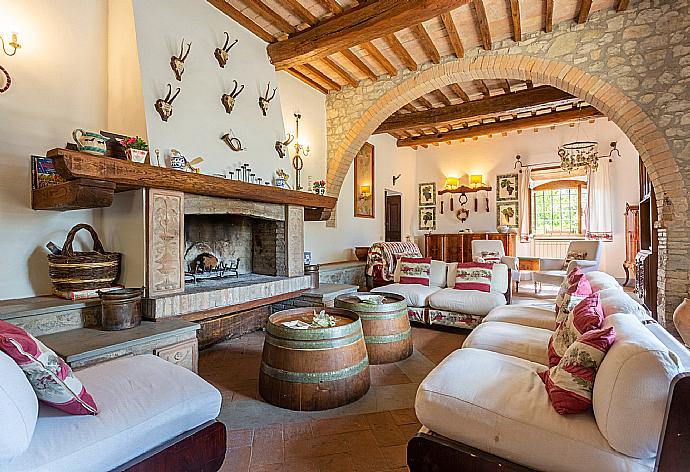 Living room on ground floor with sofas, dining area, ornamental fireplace, WiFi internet, satellite TV, and terrace access . - Villa Il Giulione . (Fotogalerie) }}