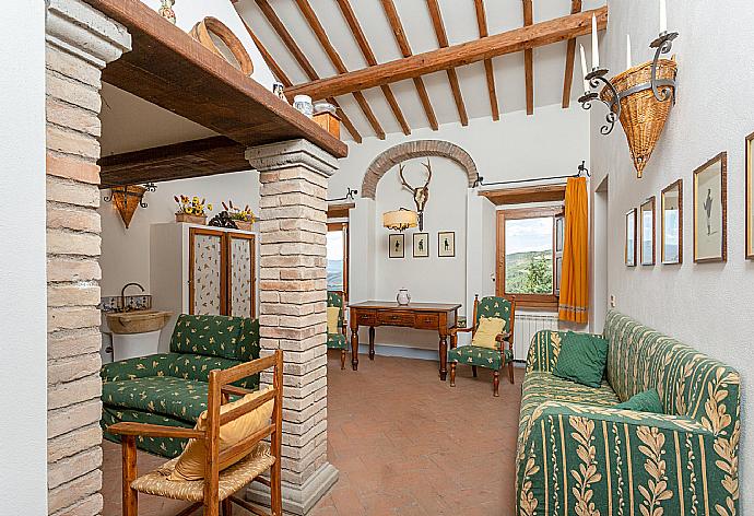 Living room on first floor with sofas and ornamental fireplace . - Villa Il Giulione . (Photo Gallery) }}