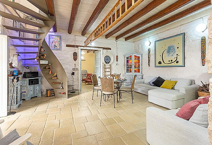 Living room with sofas, dining area, ornamental fireplace, WiFi internet, satellite TV, and terrace access . - Villa Nina . (Photo Gallery) }}