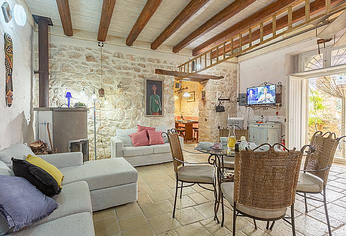 Living room with sofas, dining area, ornamental fireplace, WiFi internet, satellite TV, and terrace access . - Villa Nina . (Photo Gallery) }}