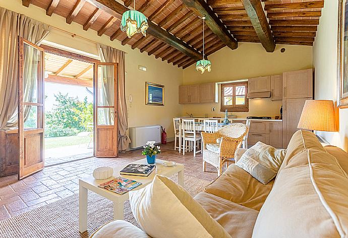 Open-plan living room in annex with sofa, dining area, kitchen, WiFi internet, satellite TV, and terrace access . - Villa Casale Federica . (Galleria fotografica) }}