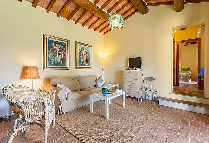 Open-plan living room in annex with sofa, dining area, kitchen, WiFi internet, satellite TV, and terrace access . - Villa Casale Federica . (Fotogalerie) }}