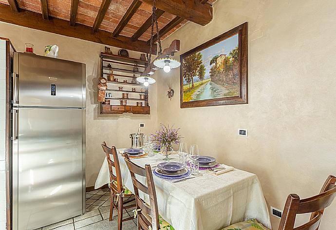 Open-plan living room with sofas, dining area, kitchen, ornamental fireplace, WiFi internet, satellite TV, and garden access . - Villa Casale Le Selve . (Fotogalerie) }}