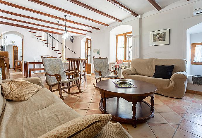 Living room with sofas, dining area, ornamental fireplace, A/C, WiFi internet, satellite TV, DVD player, and terrace access . - Villa Can Soler II . (Галерея фотографий) }}