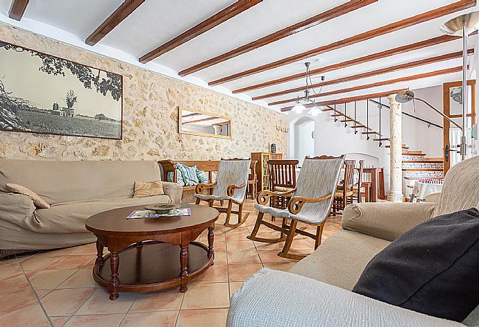 Living room with sofas, dining area, ornamental fireplace, A/C, WiFi internet, satellite TV, DVD player, and terrace access . - Villa Can Soler II . (Galería de imágenes) }}