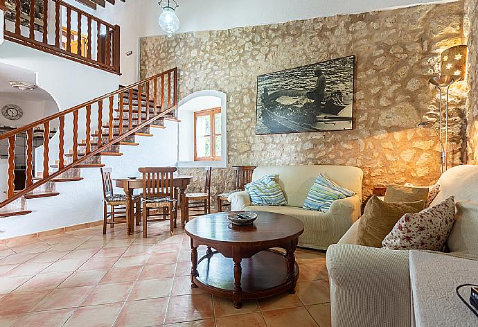 Open-plan living room with sofas, dining area, kitchen, ornamental fireplace, WiFi internet, satellite TV, DVD player, and terrace access . - Villa Can Soler I . (Galería de imágenes) }}