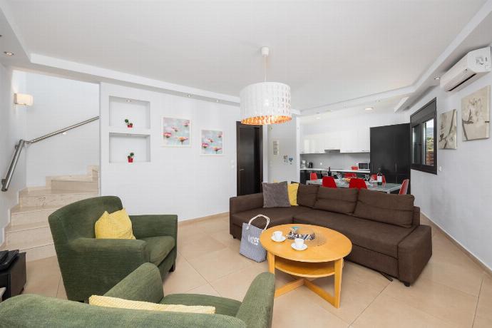 Open-plan living room with sofa, dining area, kitchen, ornamental fireplace, A/C, WiFi internet, and satellite TV . - Villa Dias . (Photo Gallery) }}