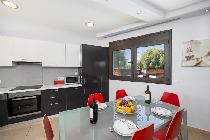 Open-plan living room with sofa, dining area, kitchen, ornamental fireplace, A/C, WiFi internet, and satellite TV . - Villa Dias . (Photo Gallery) }}