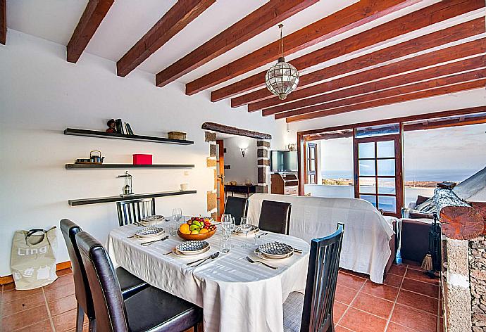 Open-plan living room with sofas, dining area, kitchen, ornamental fireplace, WiFi internet, Satellite TV, and sea views . - Villa Vista Mar . (Fotogalerie) }}