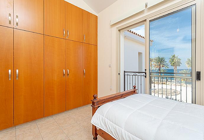 Twin bedroom with en suite bathroom, A/C, and balcony with sea views . - Villa Seashore One . (Photo Gallery) }}