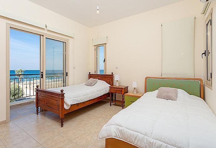 Twin bedroom with en suite bathroom, A/C, and balcony with sea views . - Villa Seashore One . (Photo Gallery) }}