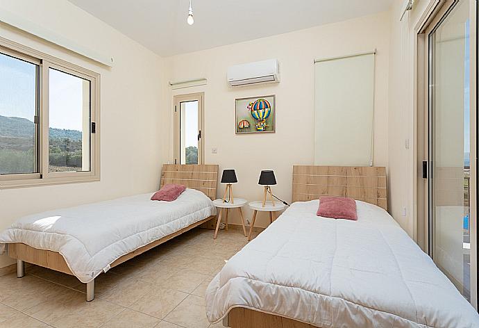 Twin bedroom with en suite bathroom, A/C, and balcony with sea views . - Villa Seashore One . (Photo Gallery) }}