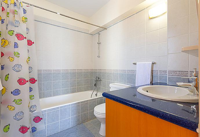 En suite bathroom with bath and shower . - Villa Seashore One . (Photo Gallery) }}