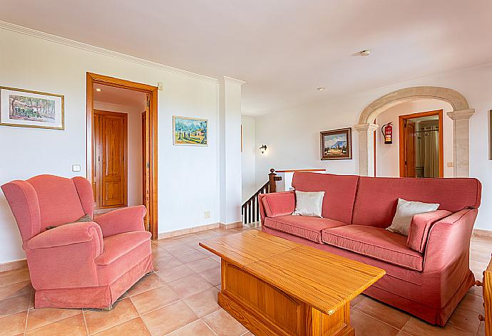Second living room on first floor with sofas, ornamental fireplace, TV, and upper terrace access . - Villa Padilla . (Галерея фотографий) }}