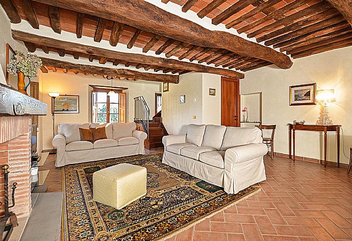 Living room with fireplace, TV and terrace access . - Villa Casale di Rosa . (Galleria fotografica) }}