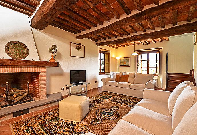 Living room with fireplace, TV and terrace access . - Villa Casale di Rosa . (Galleria fotografica) }}