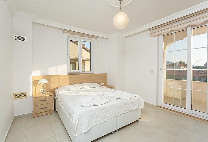 Double bedroom with en suite bathroom, A/C, TV, and balcony access . - Villa Kubra . (Galerie de photos) }}