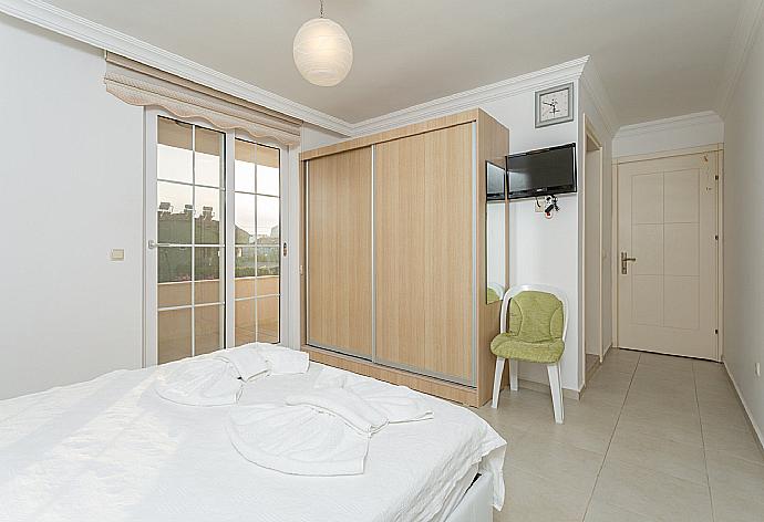 Double bedroom with en suite bathroom, A/C, TV, and balcony access . - Villa Kubra . (Photo Gallery) }}