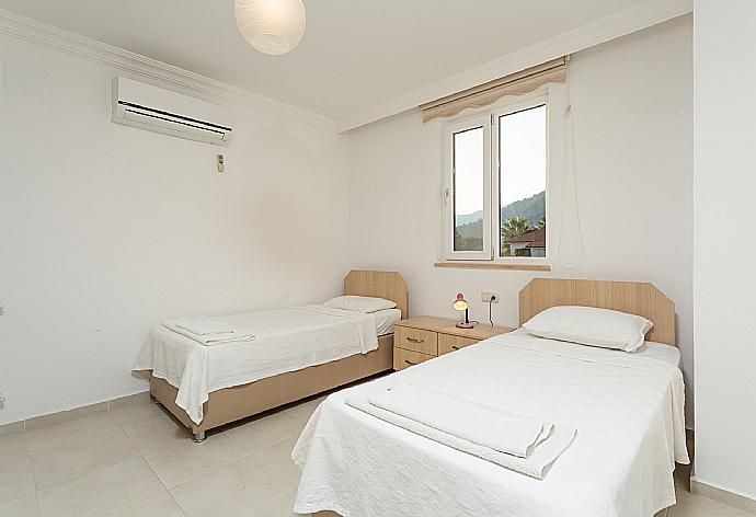 Twin bedroom with en suite bathroom, A/C, and balcony access . - Villa Kubra . (Photo Gallery) }}