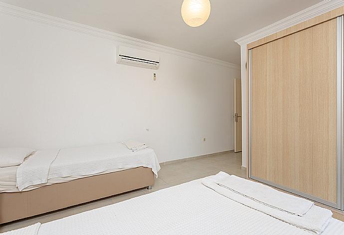 Twin bedroom with en suite bathroom, A/C, and balcony access . - Villa Kubra . (Photo Gallery) }}