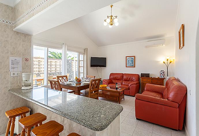 Open-plan living room with sofas, dining area, kitchen, A/C, WiFi internet, satellite TV, and terrace access . - Villa Zoe . (Fotogalerie) }}