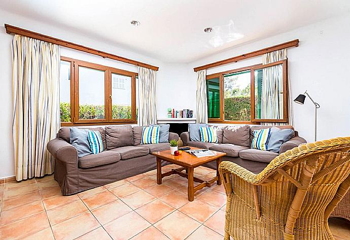 Open-plan living room with sofas, dining area, kitchen, WiFi internet, satellite TV, and terrace access . - Villa Binimelis . (Fotogalerie) }}