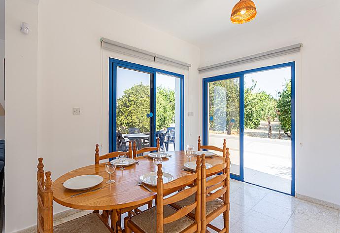 Open-plan living room with sofas, dining area, kitchen, WiFi internet, satellite TV, DVD player, and terrace access . - Villa Charoula Pente . (Galerie de photos) }}