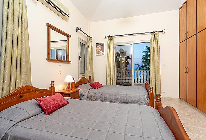 Twin bedroom with en suite bathroom, A/C, and balcony with sea views . - Villa Jan Lui . (Photo Gallery) }}