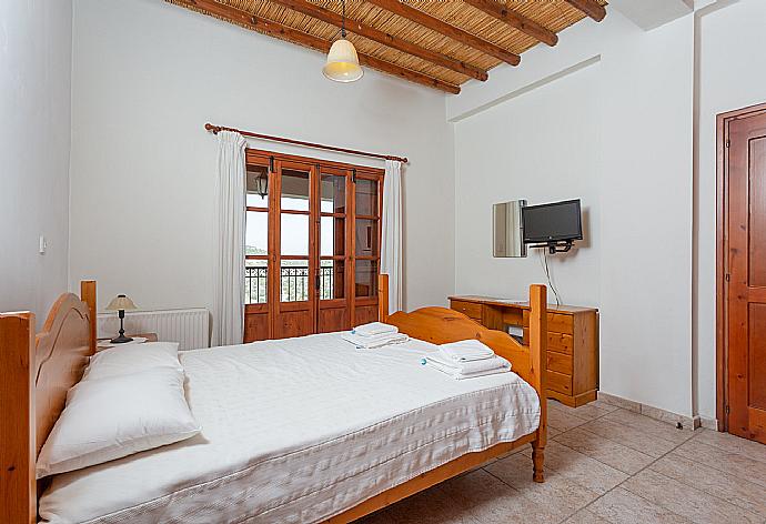 Double bedroom with en suite bathroom, A/C, TV, and balcony access . - Villa Alexandros Palace . (Photo Gallery) }}