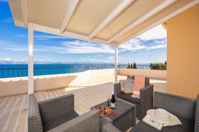 Sheltered terrace area with sea views . - Villa Litsa . (Photo Gallery) }}