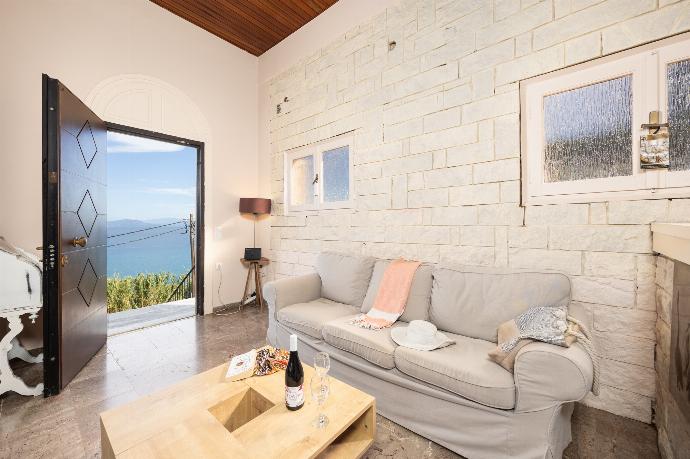 Living room with sofas, ornamental fireplace, A/C, WiFi internet, satellite TV, and sea views . - Villa Litsa . (Photo Gallery) }}