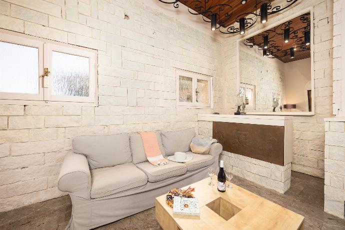 Living room with sofas, ornamental fireplace, A/C, WiFi internet, satellite TV, and sea views . - Villa Litsa . (Photo Gallery) }}