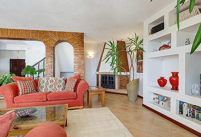 Living room with sofas, ornamental fireplace, WiFi internet, satellite TV, DVD player, and terrace access . - Villa Alto da Boa . (Photo Gallery) }}