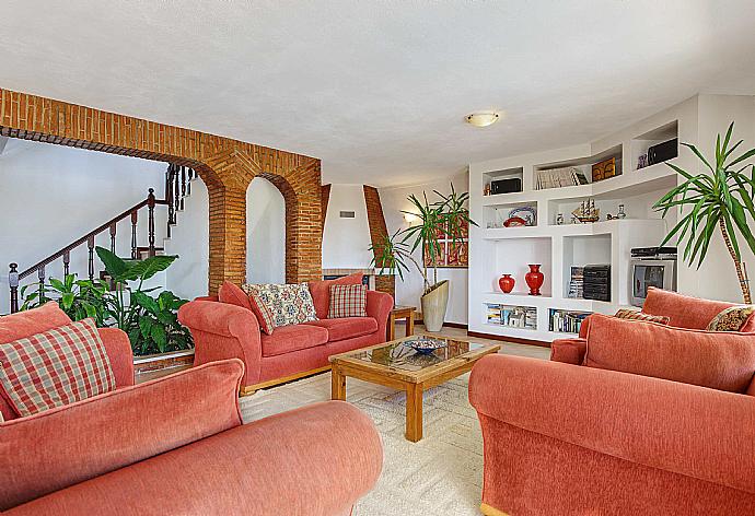 Living room with sofas, ornamental fireplace, WiFi internet, satellite TV, DVD player, and terrace access . - Villa Alto da Boa . (Photo Gallery) }}