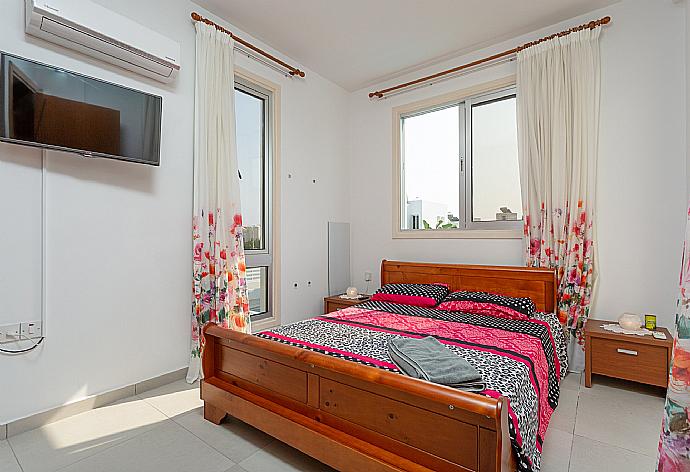 Double bedroom with A/C, satellite TV, and balcony access . - Villa Faros . (Галерея фотографий) }}