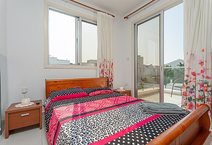 Double bedroom with A/C, satellite TV, and balcony access . - Villa Faros . (Photo Gallery) }}