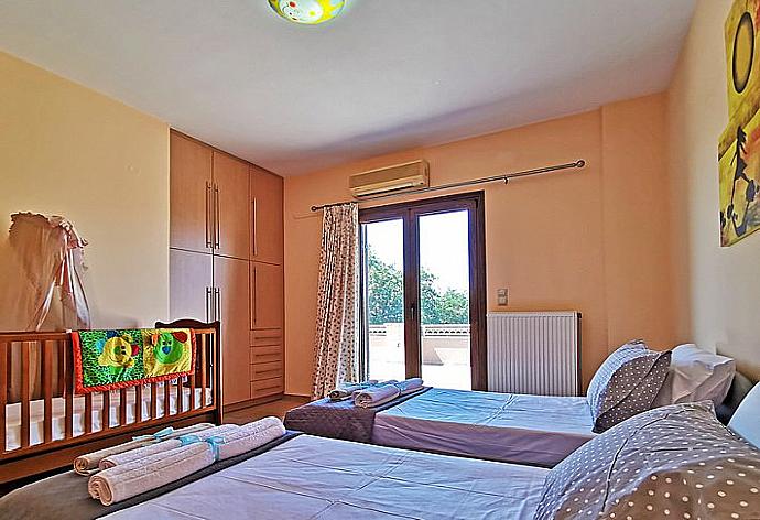 Twin bedroom and  baby cot  . - Iris Villa . (Photo Gallery) }}