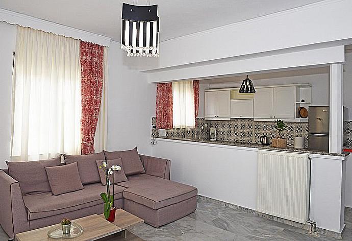 Open-plan living room with sofa, dining area, kitchen . - Platanias Villa Spyros . (Photo Gallery) }}