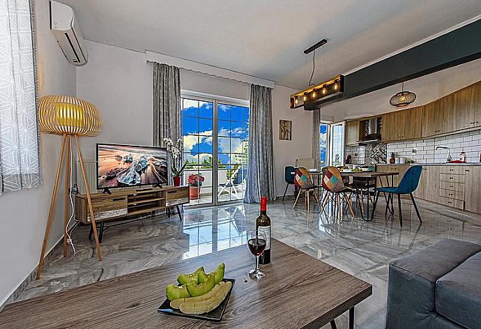 Open-plan living room with sofa, dining area, kitchen . - Platanias Villa Spyros . (Galería de imágenes) }}