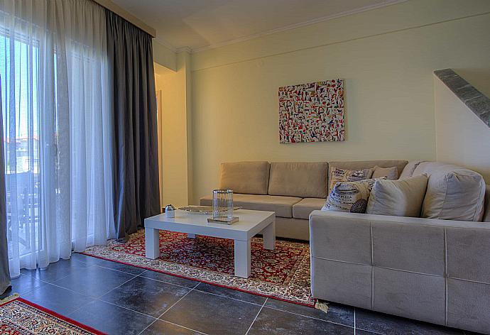 Living room with dining area and terrace access . - Grand Villa Athos . (Photo Gallery) }}